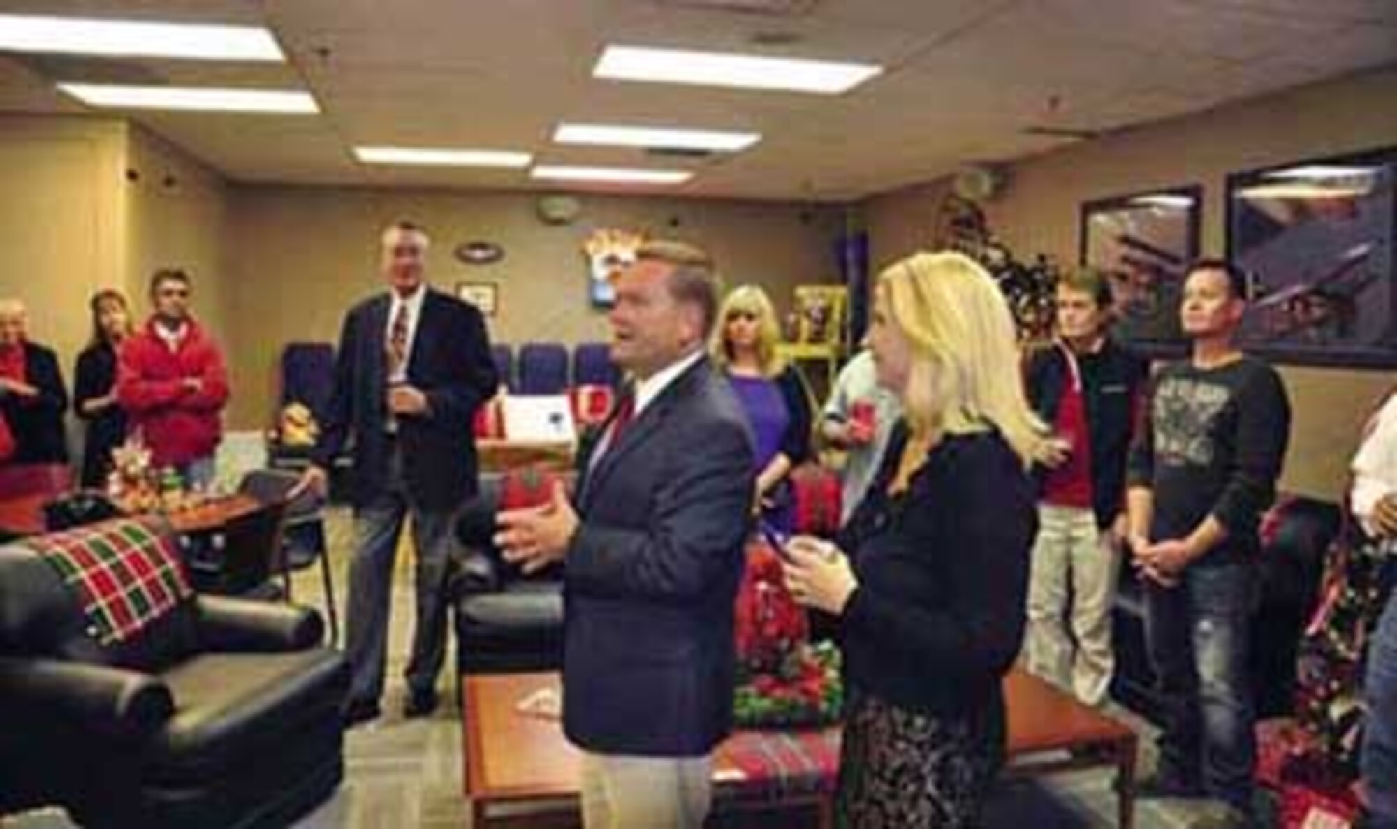Colonel Samuel Mahaney, 452d Air Mobility Wing commander (center) and his wife, Chris, welcome local community leaders to the wing’s annual holiday reception, held Dec. 1, in the operations group building. The reception, sponsored by the Chief’s Group and the First Sergeant’s Council, is held to thank the community members for their support of the base throughout the year. (U.S. Air Force photo by Lt. Col. Don Traud)