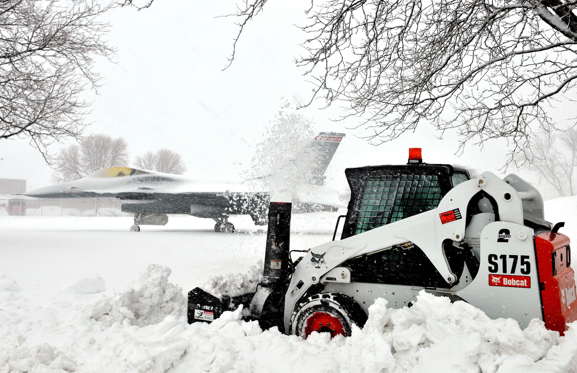 Chief Master Sgt. David Martin, 115th Civil Engineer Squadron, clears walking paths at Truax Field's 115th Fighter Wing as Winter Storm Draco continues to drop snow across the Northern Midwest Dec. 20. Although many local businesses and school are closed throughout the area, the 115th Fighter Wing remains open and ready for business. “The Wisconsin Air National Guard stands ready to execute our state mission, including domestic operations, by supporting relief efforts during natural disasters -- such as severe blizzards,” said 115th Fighter Wing Commander Col. Jeffrey Wiegand. “Our Airmen are ready, trained and equipped to respond on a moment’s notice.” Wisconsin Air National Guard photo by Tech. Sgt. Jon LaDue