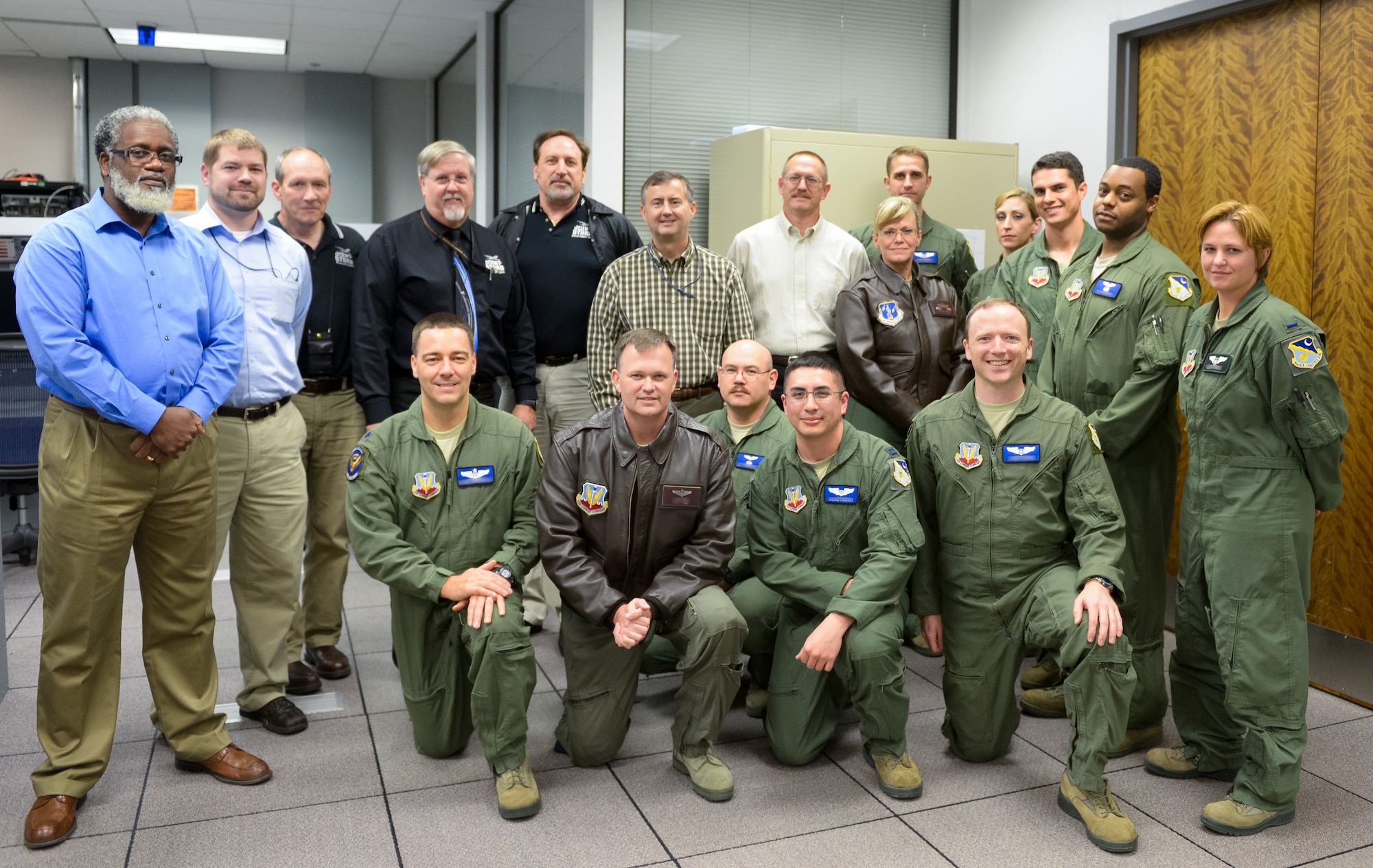 Members of the 116th Operations Group, 461st OG, and Northrop Grumman pose for a group photo in the Joint STARS mission simulator at Robins Air Force Base.  Team JSTARS reached a milestone logging more than 40,000 training hours in the mission simulator during the past 10 years. (National Guard photo by Master Sgt. Roger Parsons)
