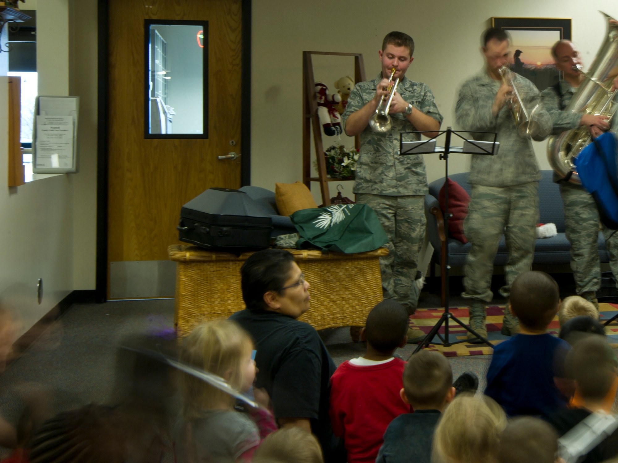 (Right) Senior Master Sgt. Vivian Bolden, 22nd Force Support Squadron professional development coordinator, performs with the Heartland of America Band Dec. 19, 2012, McConnell Air Force Base, Kan. Annually the band performs approximately 450 concerts and where they spread holiday cheer and thank Airmen for their work. (U.S. Air Force photo/Senior Airman Armando A. Schwier-Morales)