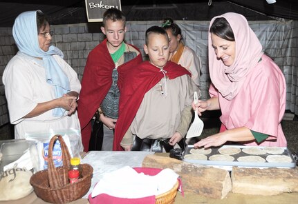 Shopkeepers make unleavened bread at the bakery on the grounds of the Main Post Chapel, which was transformed into a crowded Bethlehem Village Dec. 14 and 15. The Joint Base San Antonio-Fort Sam Houston chapel community offered participants a hands-on experience of what things might have been like during the time of Jesus’ birth. The event included crafts, skits, music, snacks
and scripture.
Photo by Ed Dixon