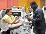 Melissa Cadena takes advice from Shane Sheffield, lead recreation
assistant, at the Jimmy Brought Fitness Center.
Photo by Deyanira Romo Rossell