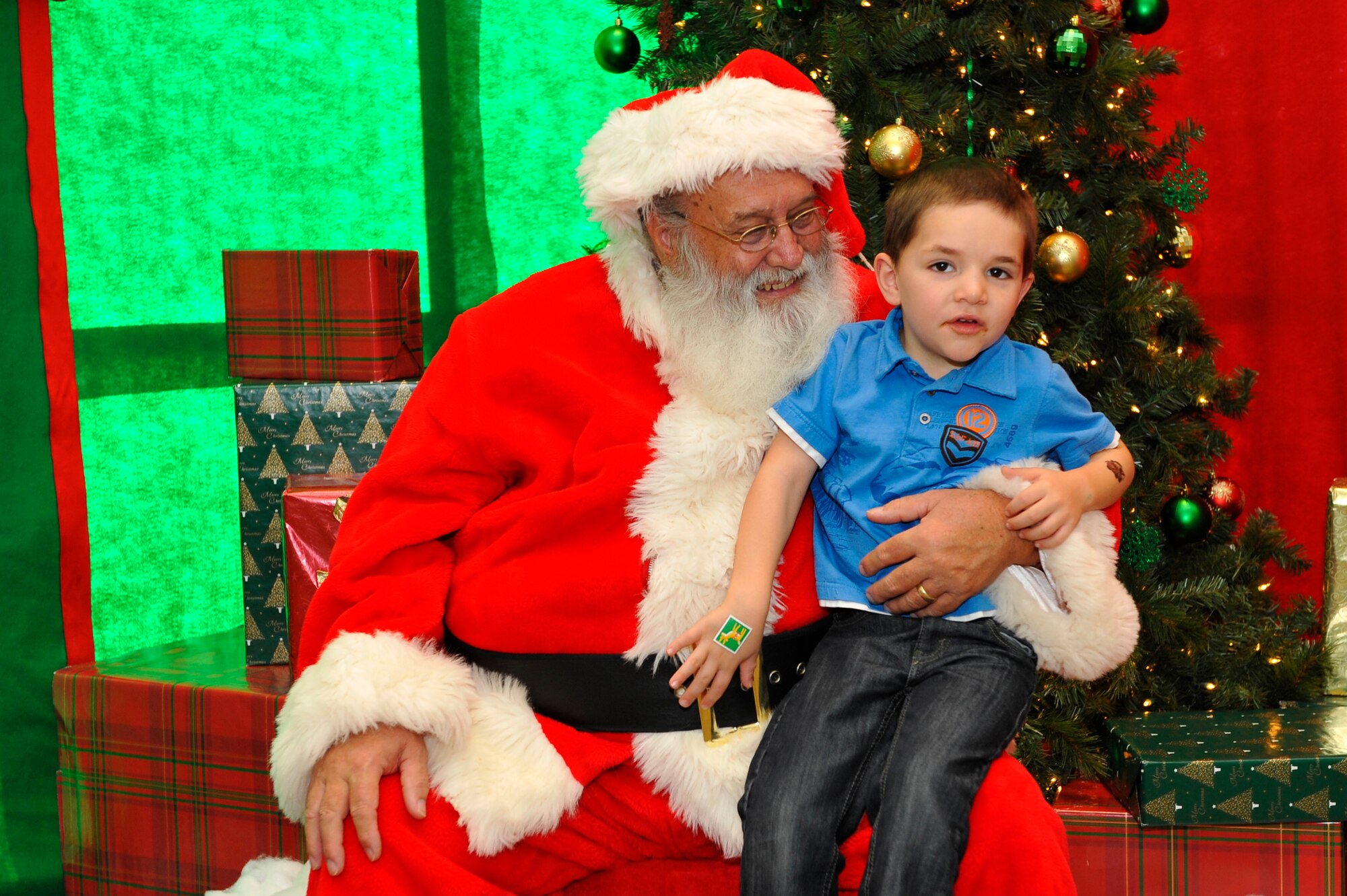 BUCKLEY AIR FORCE BASE, Colo. – Logan, son of Tech. Sgt. Matthew Sullivan, 460th Space Communications Squadron, tells Santa Claus what he wants for Christmas during the Breakfast with Santa event Dec. 8, 2012, at the Leadership Development Center. This yearly event kicks off the holiday season by providing food, gifts and a visit with Santa Claus for local military children. (U.S. Air Force photo by Airman 1st Class Phillip Houk)