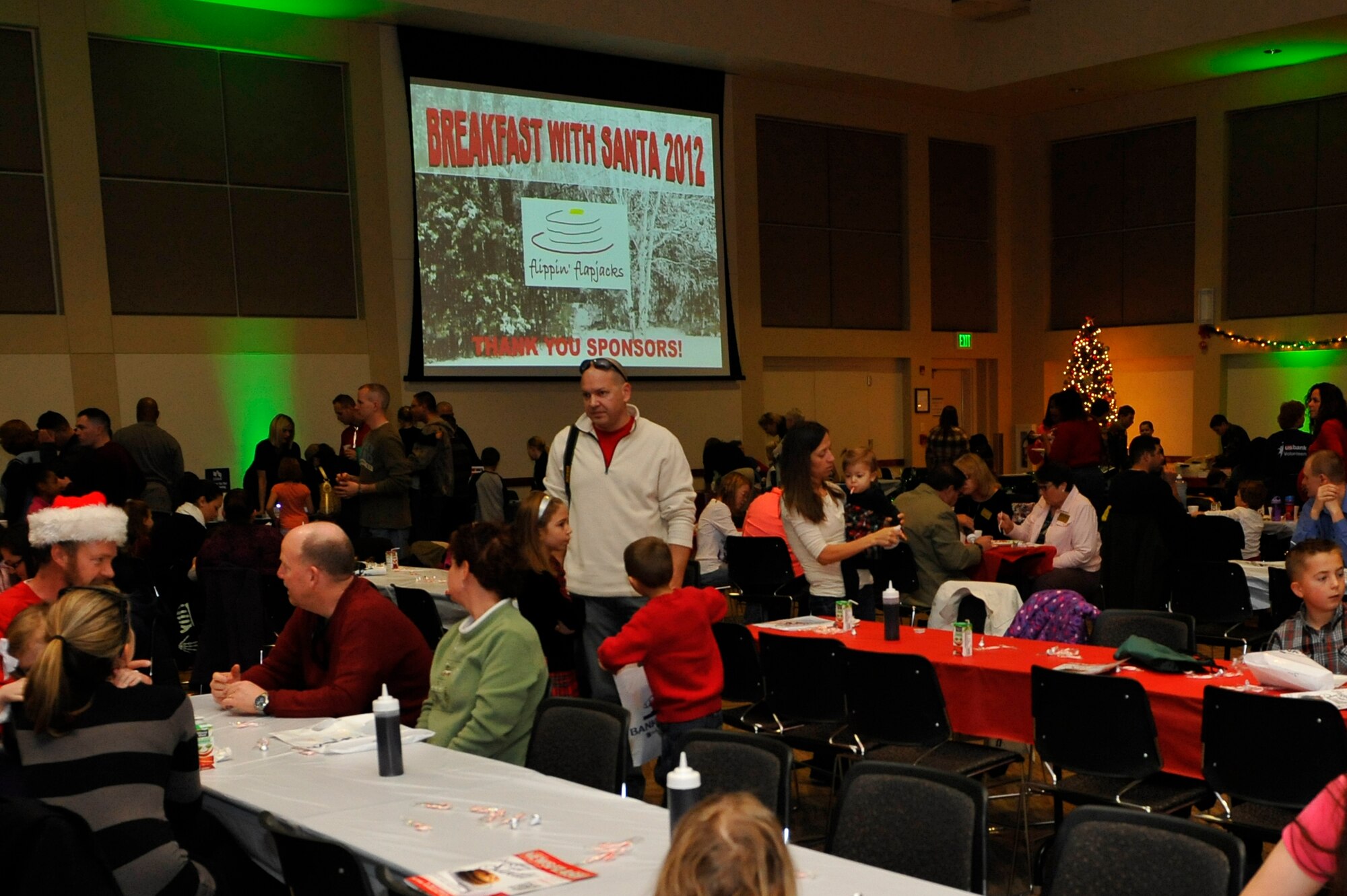 BUCKLEY AIR FORCE BASE, Colo. – Family members of Team Buckley eat pancakes in anticipation of meeting Santa Claus Dec. 8, 2012, at the Leadership Development Center during the Breakfast with Santa event. Breakfast with Santa is a yearly event coordinated by the 460th Force Support Squadron. At the event, the 460th FSS provided breakfast, a meeting with Santa Claus and gifts. (U.S. Air Force photo by Airman 1st Class Phillip Houk)