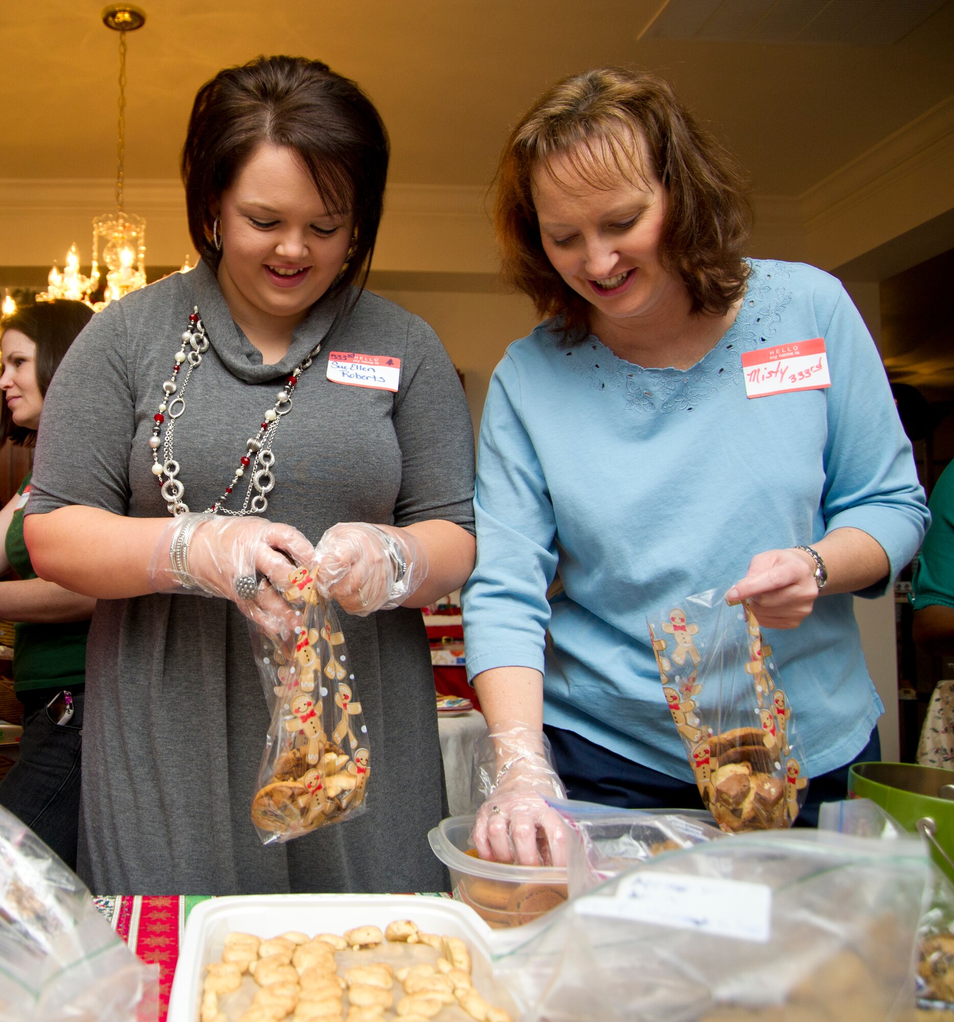 Sue Ellen Roberts, spouse of Capt. Scott Roberts, 333rd Training Squadron and Misty LeBlanc, spouse of Master Sgt. Robert LeBlanc, 333rd TRS, fill bags with an assortment of cookies with Linda Worth, spouse of Lt. Col. Brian Worth, 81st Training Group deputy commander, in her Bay Ridge home Dec. 17, 2012, at Keesler Air Force Base, Miss.  Keesler spouses held a cookie exchange and student cookie drive to collect and distribute more than 200 bags of cookies to non-prior service students staying behind over the holidays.  Col. Maureen Smith, 81st TRG commander, will deliver the cookies to students in their dormitories on Christmas Eve.  (U.S. Air Force photo by Adam Bond) 