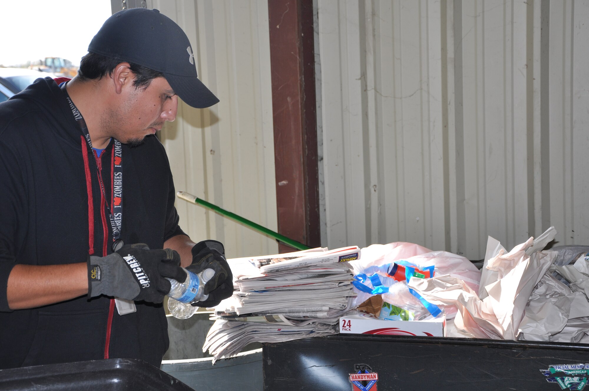 Roland Deleon, Laughlin Recycling Center recycle two associate, organizes materials at the recycling center at Laughlin Air Force Base, Texas, Dec. 19, 2012. The recycling center and compost drop off will be open 24/7 over the holiday season for all recyclable goods. (U.S. Air Force photo/2nd Lt. Evan Ross) 