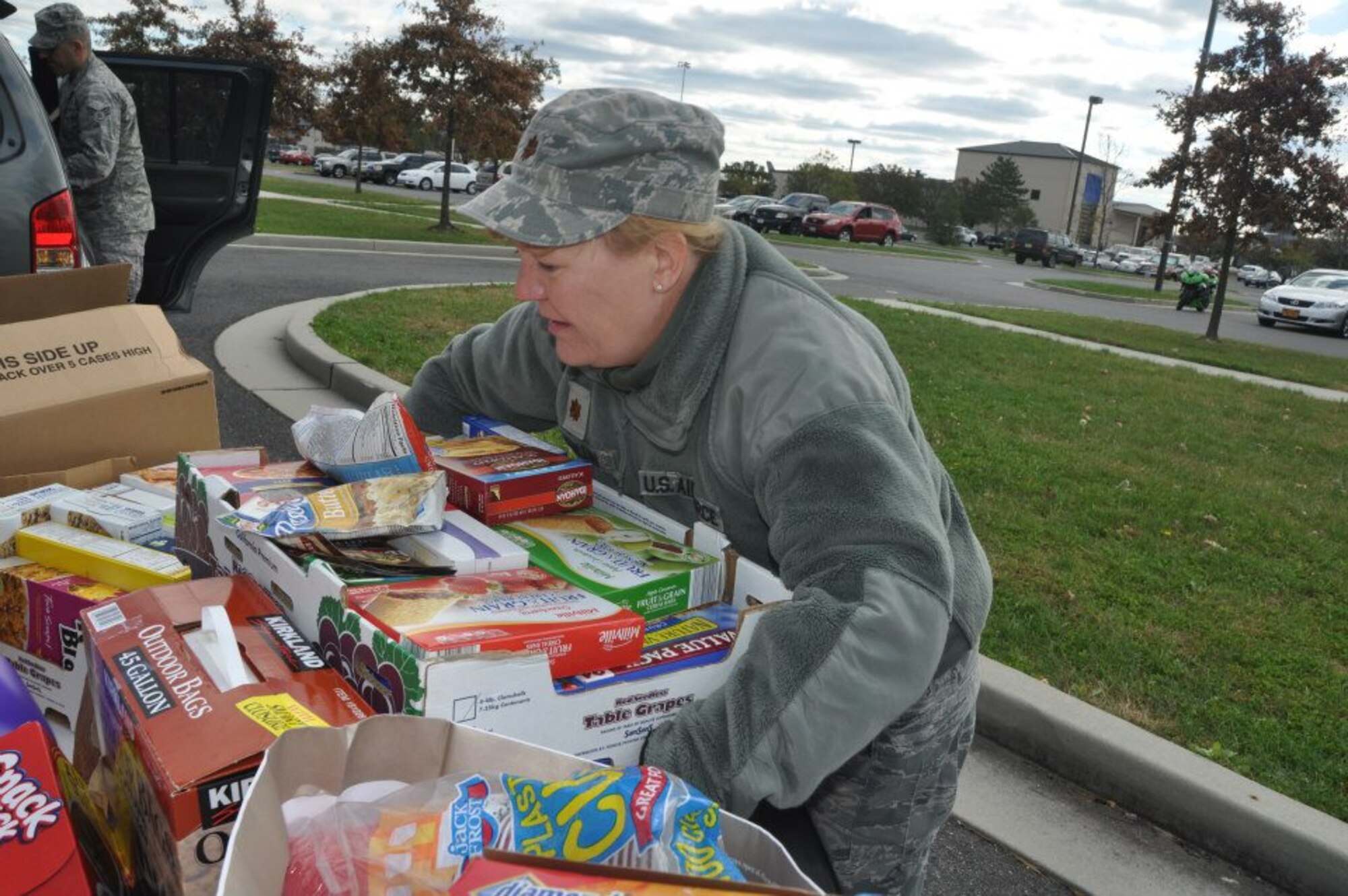 Maj. Sue McMullen, 514th Air Mobility Wing, helps unload a trailor of donations brought to Joint Base McGuire, N.J. as part of Hurricane Sandy relief efforts to the base. (Photo courtesy 514th Air Mobility Wing Public Affairs)