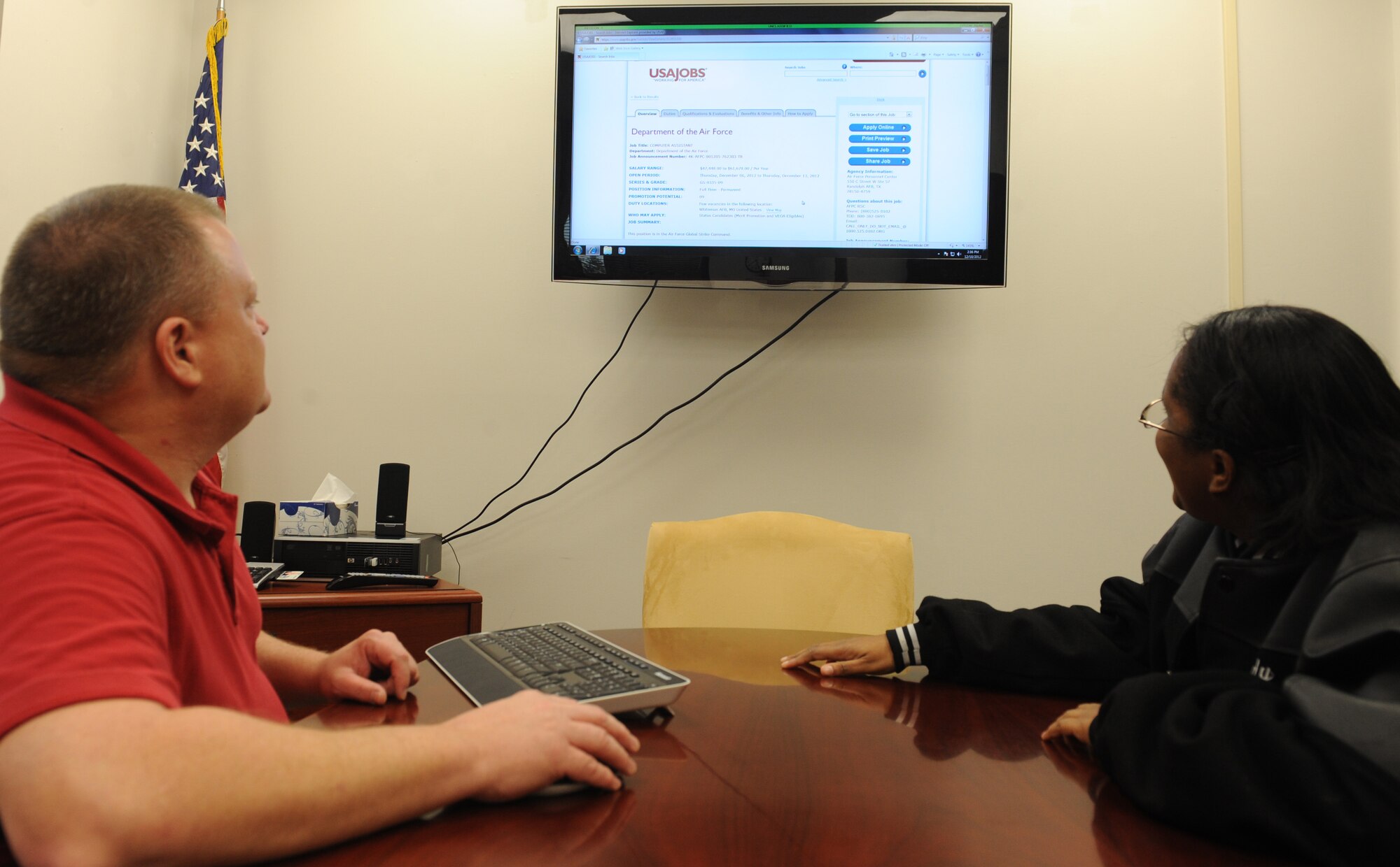 Brian Nash, 509th Force Support Squadron civilian personnel officer, helps a customer navigate the US Jobs website at the civilian personnel office, Dec. 10 at Whiteman Air Force Base, Mo. The three-person team manages 660 civilians and handles civilian personnel issues from the hiring process right to retirements. (U.S. Air Force photo/Airman 1st Class Bryan Crane)  (Released)