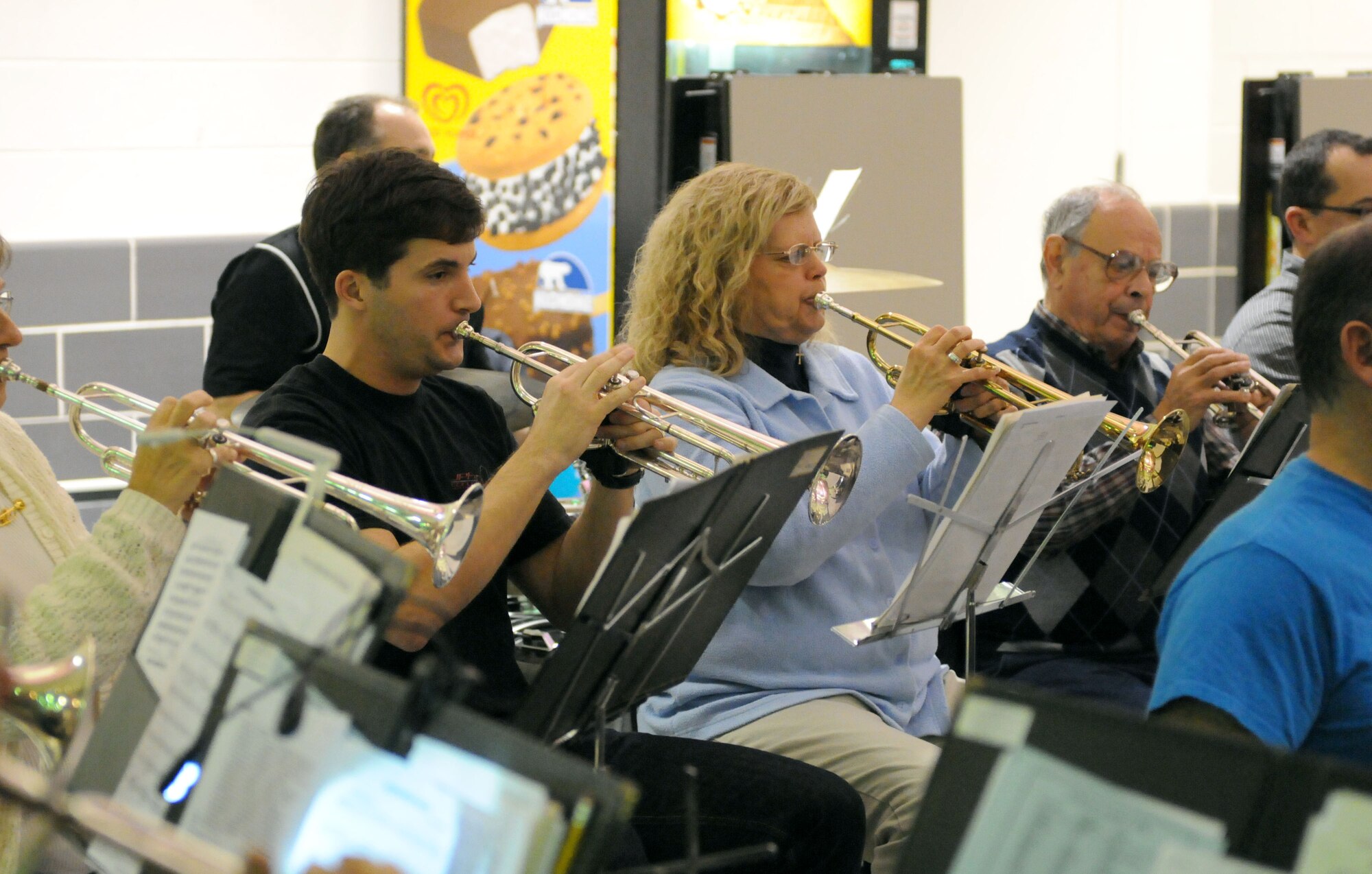Capt. Nicholas J. Ziemba (left) plays the trumpet during practice for the Golden Eagle Community Band Christmas Around the World performance Dec. 11, 2012. The Golden Eagle Community Band dates back to the 1970s, years before some of the band members were even born.(Army photo by Pfc. Chalon Hutson/Released)