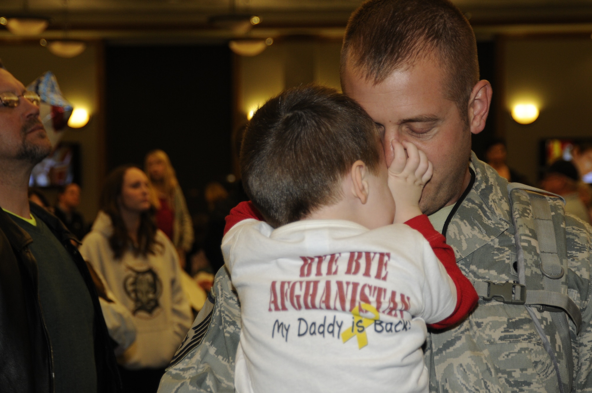 PHOTO OF THE YEAR: Master Sgt. Brian Goodhue is hugged by his son in this Jan. 9, 2012, photo from the homecoming ceremony for approximately 300 Michigan Air National Guard Airmen after a deployment to Afghanistan. The Airmen were flying and supporting the A-10 Thunderbolt II in Afghanistan. The photo, taken by TSgt. David Kujawa, is one of two photos named the 2012 Photo of the Year by the 127th Wing at Selfridge Air National Guard Base, Mich. (Air National Guard photo by TSgt. David Kujawa)