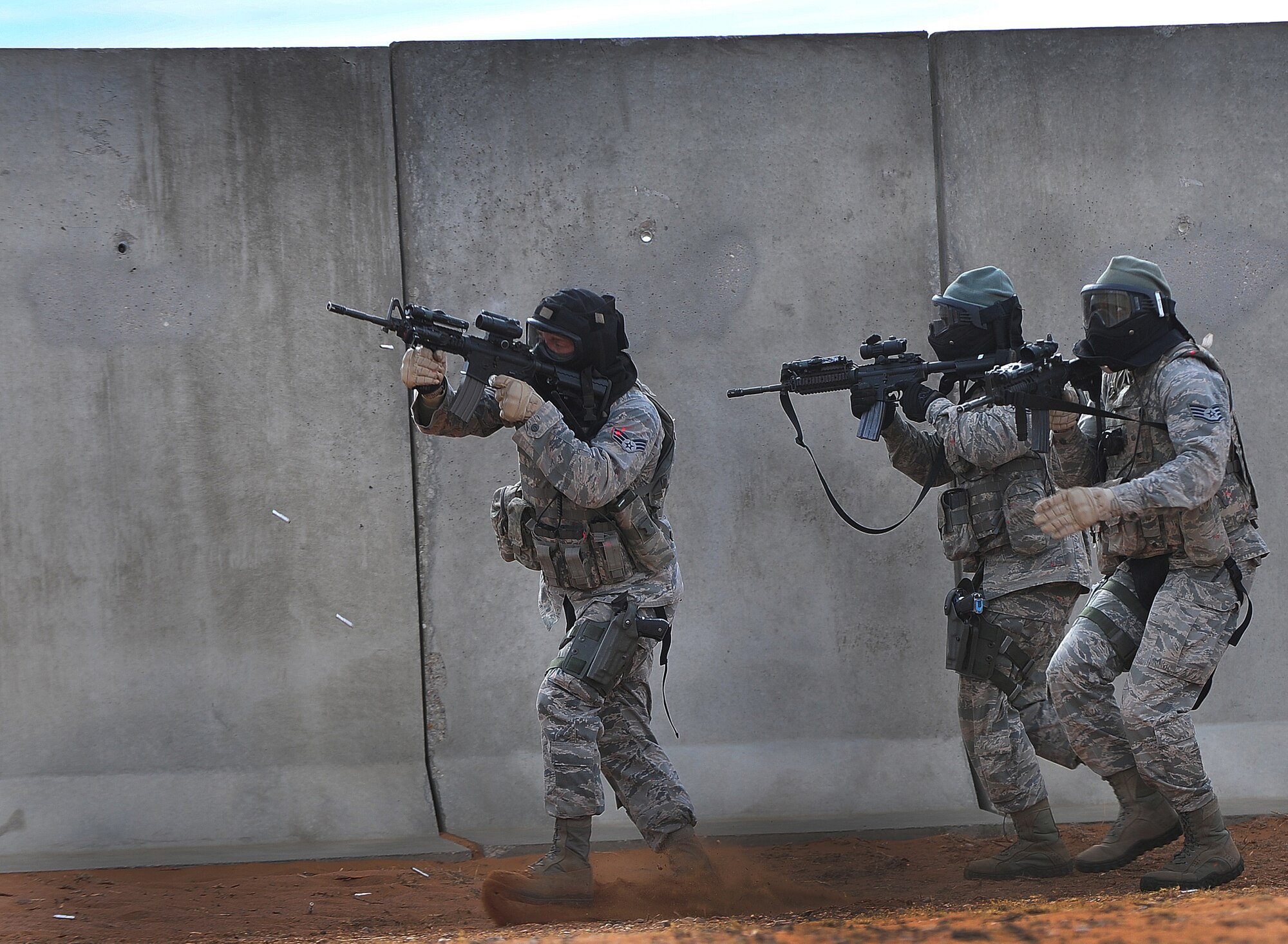 Members of the 27th Special Operations Security Forces Squadron fire simulated rounds at Opposition Forces during training at Melrose Air Force Range, N.M., Dec. 18, 2012.  This training gave the Air Commandos a chance to gain Special Operations Forces Fly Away Security Team certification.  (U.S. Air Force photo/Airman 1st Class Ericka Engblom)