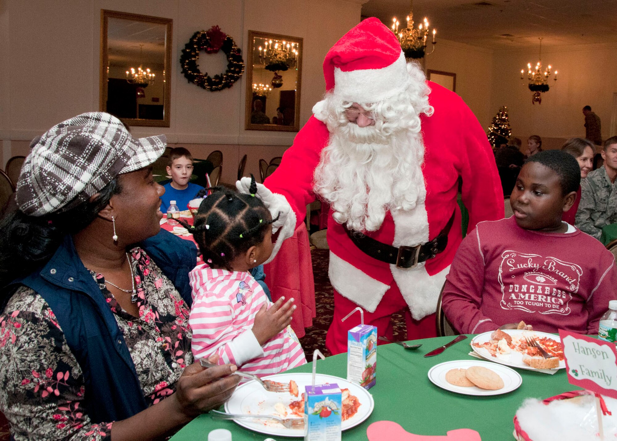 HANSCOM AIR FORCE BASE, Mass. -- Santa Claus visits families at the monthly Hearts Apart event, hosted by the Airman and Family Readiness Center, at the Minuteman Commons Dec. 18. Families of deployed military personnel were treated to an evening of holiday fun and dinner. (U.S. Air Force photo by Mark Wyatt)