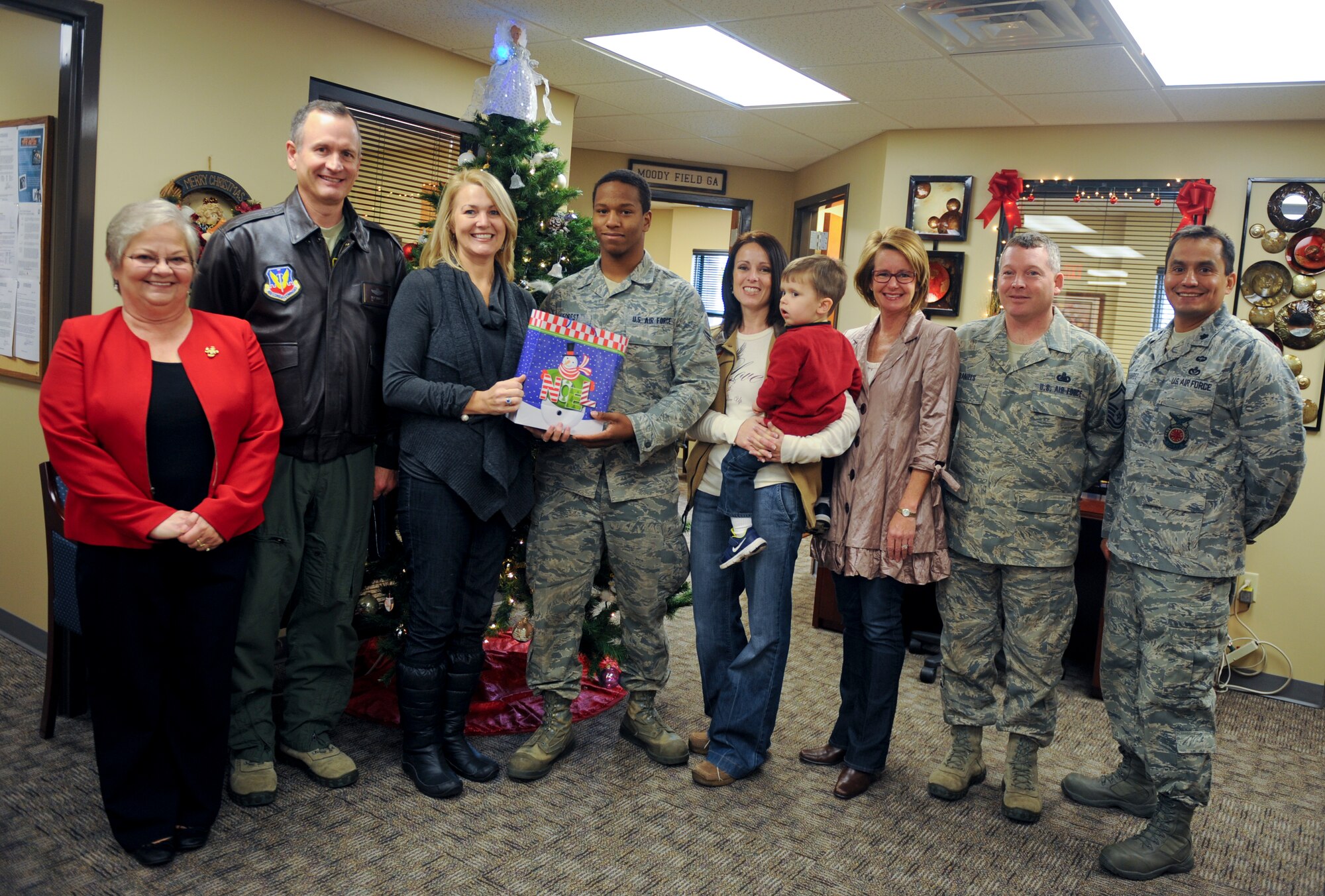U.S. Air Force Airman 1st Class Barry Forest, 723d Aircraft Maintenance Squadron, receives the first gift of toiletries from Crissy Stanley, executive director of Berrien County Chamber of Commerce, and Dawn Morisson, Downtown Development director for Nashville, at Moody Air Force Base, Ga., Dec. 14, 2012. This was the first time Nashville gathered toiletries for new Airmen to welcome and thank them for all they do. (U.S. Air Force photo by Airman 1st Class Olivia Bumpers/Released)
