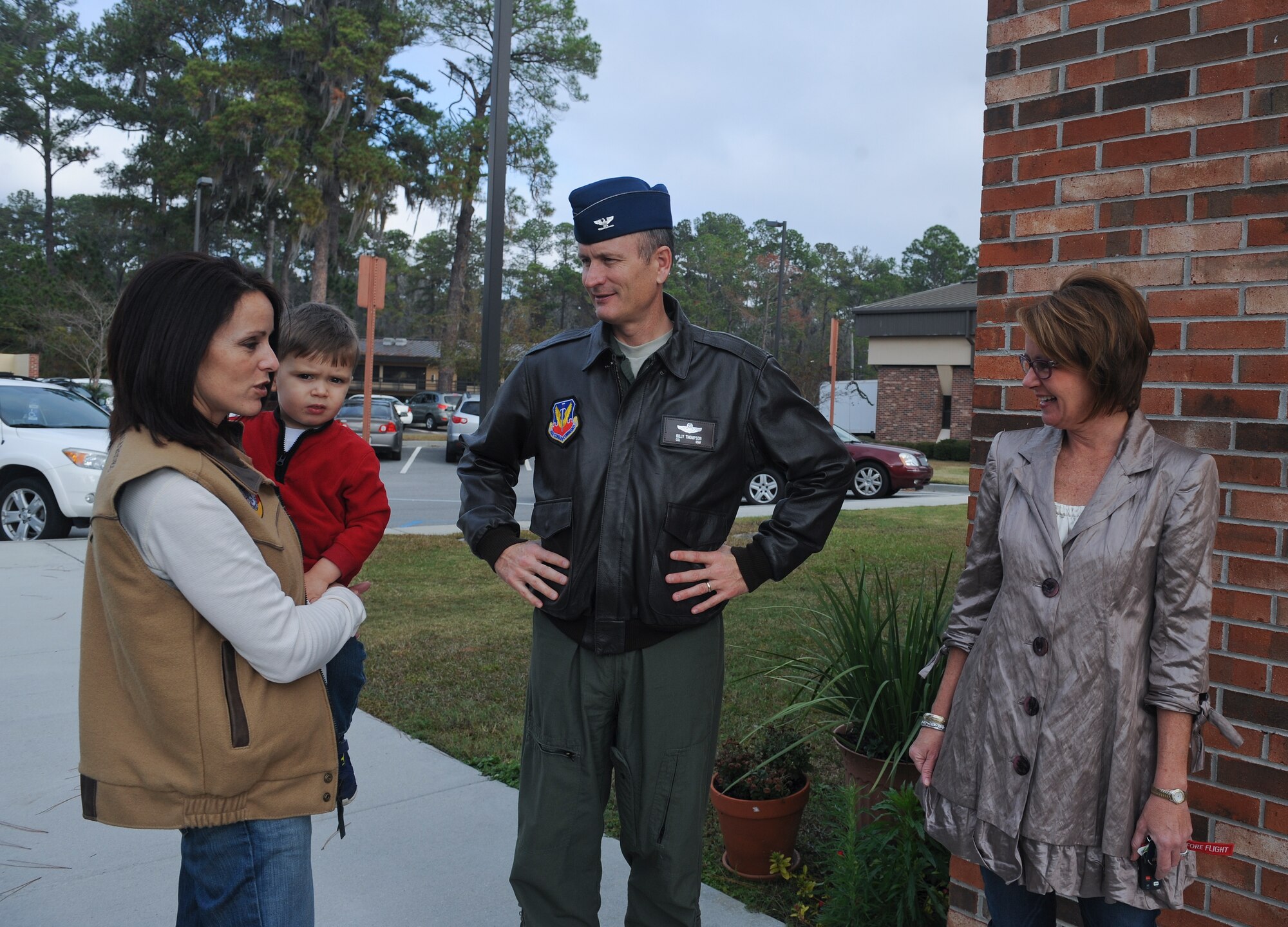 U.S. Air Force Col. Billy Thompson, 23d Wing commander, and his wife Julie, right, greet Crissy Stanley, executive director of Berrien County Chamber of Commerce, at Moody Air Force Base, Ga., Dec. 14, 2012. The Nashville community collected approximately 400 toiletry items for new Airmen on base. (U.S. Air Force photo by Airman 1st Class Olivia Bumpers/Released)