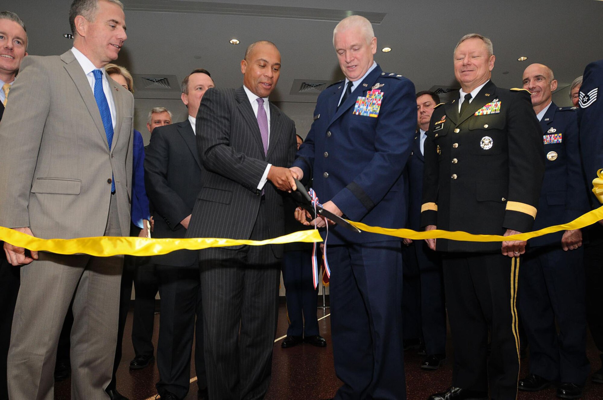 HANSCOM AIR FORCE BASE, Mass. – Gov. Deval Patrick and Maj. Gen. L. Scott Rice, The Adjutant General, Massachusetts National Guard, cut a ribbon signifying the official opening of the Massachusetts National Guard’s new Joint Force Headquarters here Dec. 13. Sen.-elect Elizabeth Warren, Gen. Frank J. Grass, National Guard Bureau chief, Lt. Gov. Tim Murray, state cabinet members and base leadership all attended the ceremony to officially welcome the guard to Hanscom. (U.S. Army photo by Staff Sgt. Jerry Saslav, Massachusetts National Guard Public Affairs)