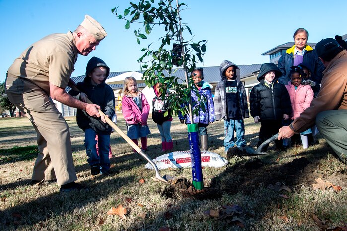 Capt. Thomas Bailey, Joint Base Charleston deputy commander and Keith Thompson, JB Charleston conservation program manager, along with kids from the General Thomas R. Mikolajcik Child Development plant a tree on Arbor Day on Dec. 14, 2012, at Joint Base Charleston - Air Base, S.C. This is the 17th year JB Charleston has been a member of the Tree City USA foundation. To become a Tree City USA member, a community must meet four annual standards: must be a tree protection board or manager, a tree care ordinance, a comprehensive community forestry program, and an Arbor Day observance. (U.S. Air Force photo/Staff Sgt. Rasheen Douglas)