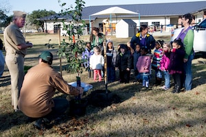 Capt. Thomas Bailey, Joint Base Charleston deputy commander and Keith Thompson, JB Charleston conservation program manager, talk to kids about Arbor Day on Dec. 14, 2012, at the General Thomas R. Mikolajcik Child Development at Joint Base Charleston - Air Base, S.C. This is the 17th year JB Charleston has been a member of the Tree City USA foundation. To become a Tree City USA member, a community must meet four annual standards: must be a tree protection board or manager, a tree care ordinance, a comprehensive community forestry program, and an Arbor Day observance. (U.S. Air Force photo/Staff Sgt. Rasheen Douglas)