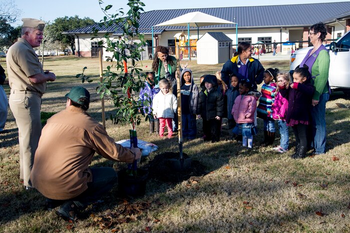 Capt. Thomas Bailey, Joint Base Charleston deputy commander and Keith Thompson, JB Charleston conservation program manager, talk to kids about Arbor Day on Dec. 14, 2012, at the General Thomas R. Mikolajcik Child Development at Joint Base Charleston - Air Base, S.C. This is the 17th year JB Charleston has been a member of the Tree City USA foundation. To become a Tree City USA member, a community must meet four annual standards: must be a tree protection board or manager, a tree care ordinance, a comprehensive community forestry program, and an Arbor Day observance. (U.S. Air Force photo/Staff Sgt. Rasheen Douglas)