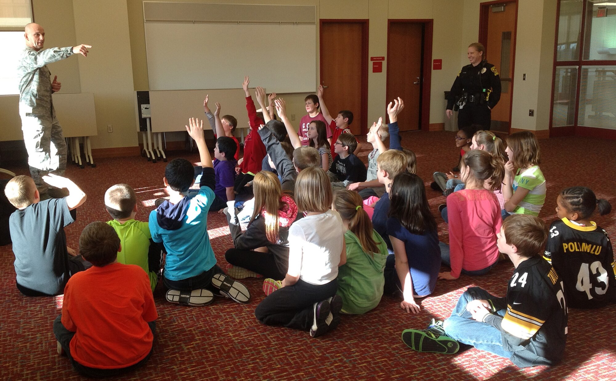 Master Sgt. Paul E. McInnis, 911th Airlift Wing fitness program manager, visits Moon Middle School 5th graders, Dec. 14, 2012, for some Boot Camp fitness training.  Here, McInnis receives input from a group of students on the types of fitness activities they enjoy, and talks about the Air Force Core Values and how they translate into civilian life.  More than 135 5th-grade students signed up to participate in the program which will run until the end of the school year.  The goal of the program is to build team work and teach simple principles of the military, including physical training and conduct.  The program will be offered to the other middle school grades beginning next school year. 