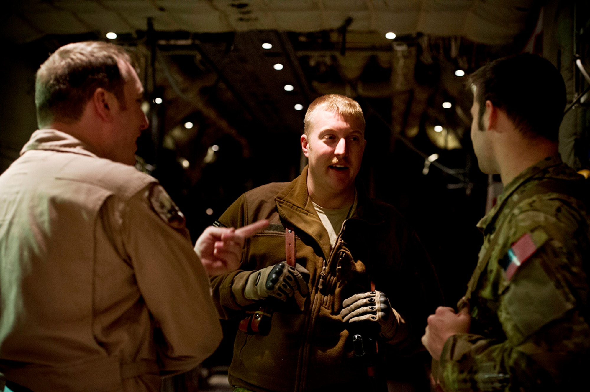 From left, U.S. Air Force Staff Sgt. Jonathan Snyder, Tech. Sgt. Dave Hoffer and 1st Lt. John Fugate discuss an upcoming flight mission at Kandahar Airfield, Afghanistan, Dec. 12. All three Airmen attended DuBois Area High School in DuBois, Penn., and though their career paths went in different directions after graduation, the circumstances of their deployment reunited them for the mission. (U.S. Air Force photo/Staff Sgt. Eric Burks)