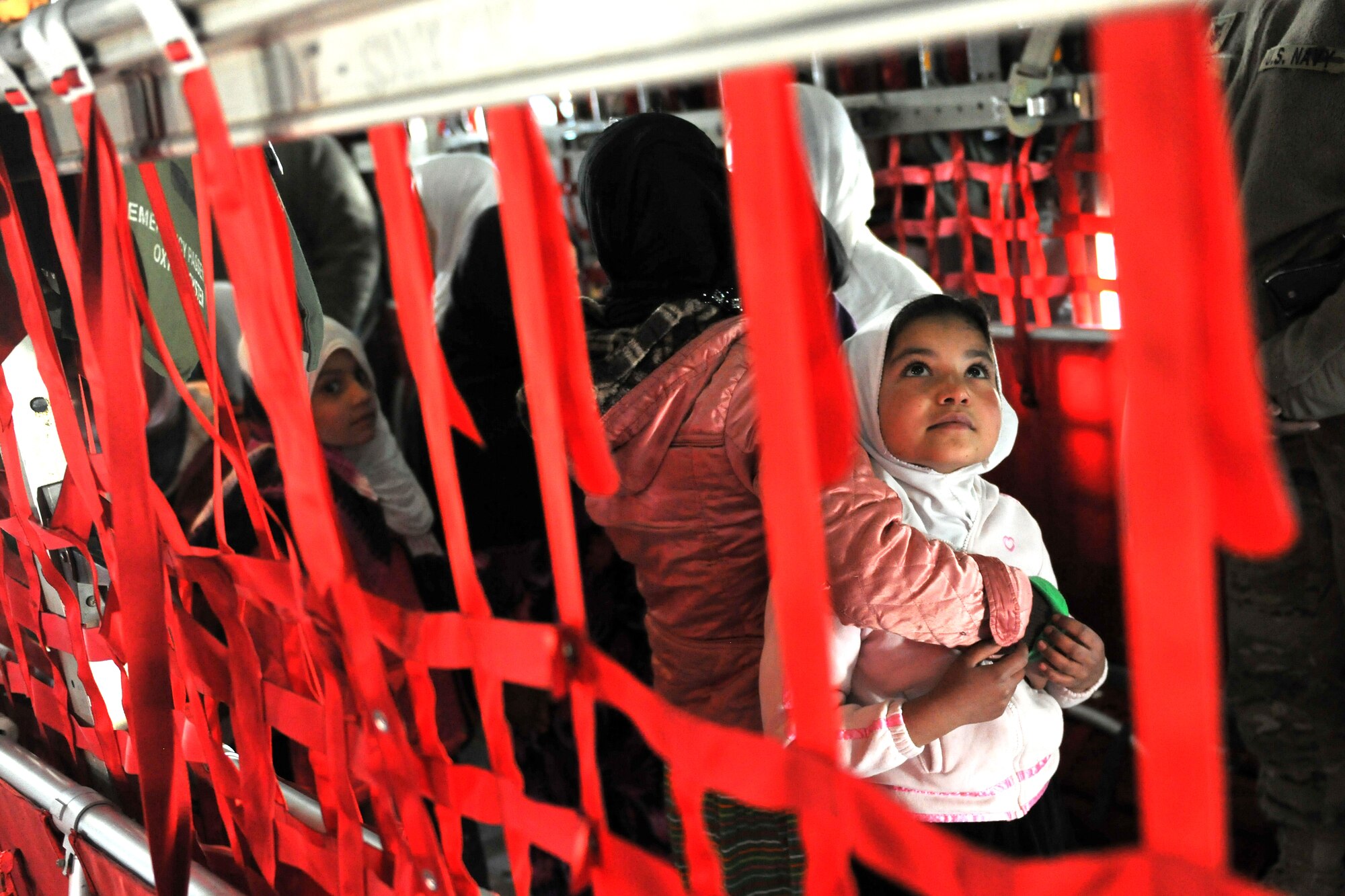 Local Afghan girls enrolled in the “Cat in the Hat” education program take a tour of a C-130 Hercules at Bagram Airfield, Afghanistan, Dec. 20, 2012. The program is a volunteer-run community outreach effort designed to provide local Afghan children a safe, nurturing learning environment in which they are inspired to bring positive change to Afghanistan. (U.S. Air Force photo/Senior Airman Chris Willis)
