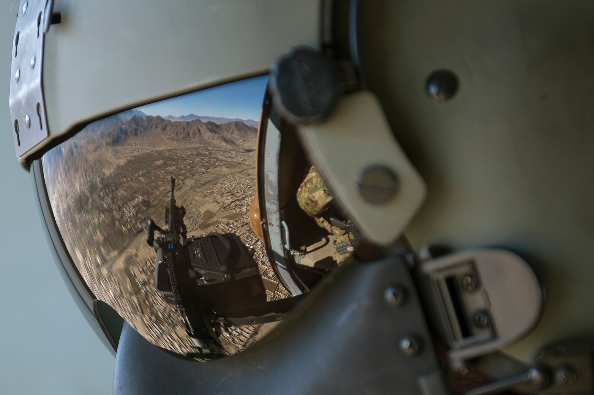 Czech Air Force Warrant Officer Milan Rubes, a door gunner, scans the ground for threats from an Afghan Air Force Mi-17 helicopter during a mission from Kabul, Afghanistan, International Airport, Dec. 1, 2012. The flight familiarized the newly arrived Czech aircrew with the Kabul area. (U.S. Air Force photo/Tech. Sgt. Dennis J. Henry Jr.)