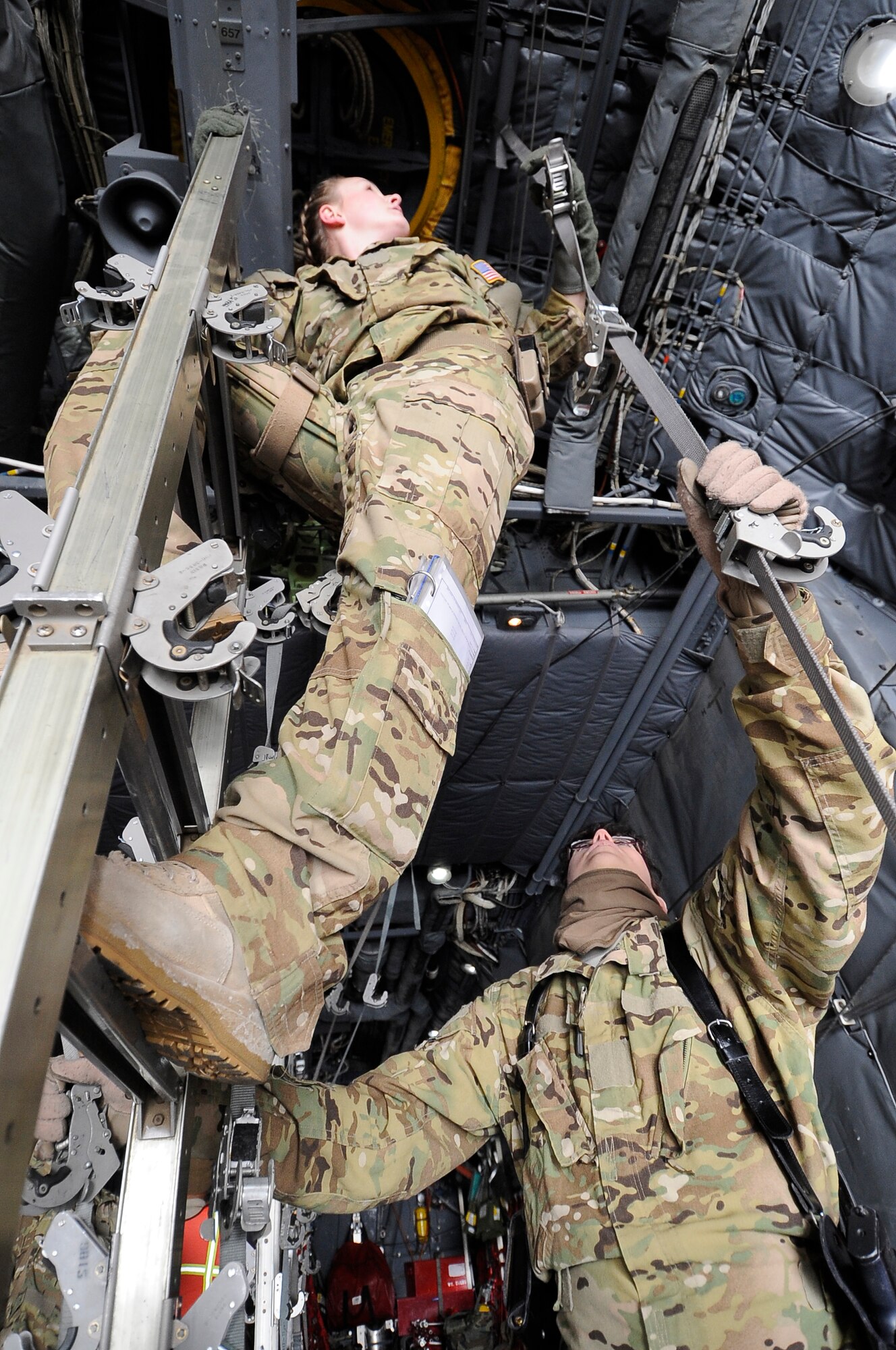 Capt. Deanna Leyba and Senior Airman Erin Smith reconfigure the litter straps on a C-130 Hercules here to prepare the aircraft for a “bandage mission” to transport patients throughout Afghanistan on Dec. 18, 2012. Leyba, a flight nurse, and Smith, a medical technician, are both members of the 455th Expeditionary Aeromedical Evacuation Squadron deployed here from Peterson Air Force Base, Colo. (U.S. Air Force Photo/Master Sgt. Jun Kim)