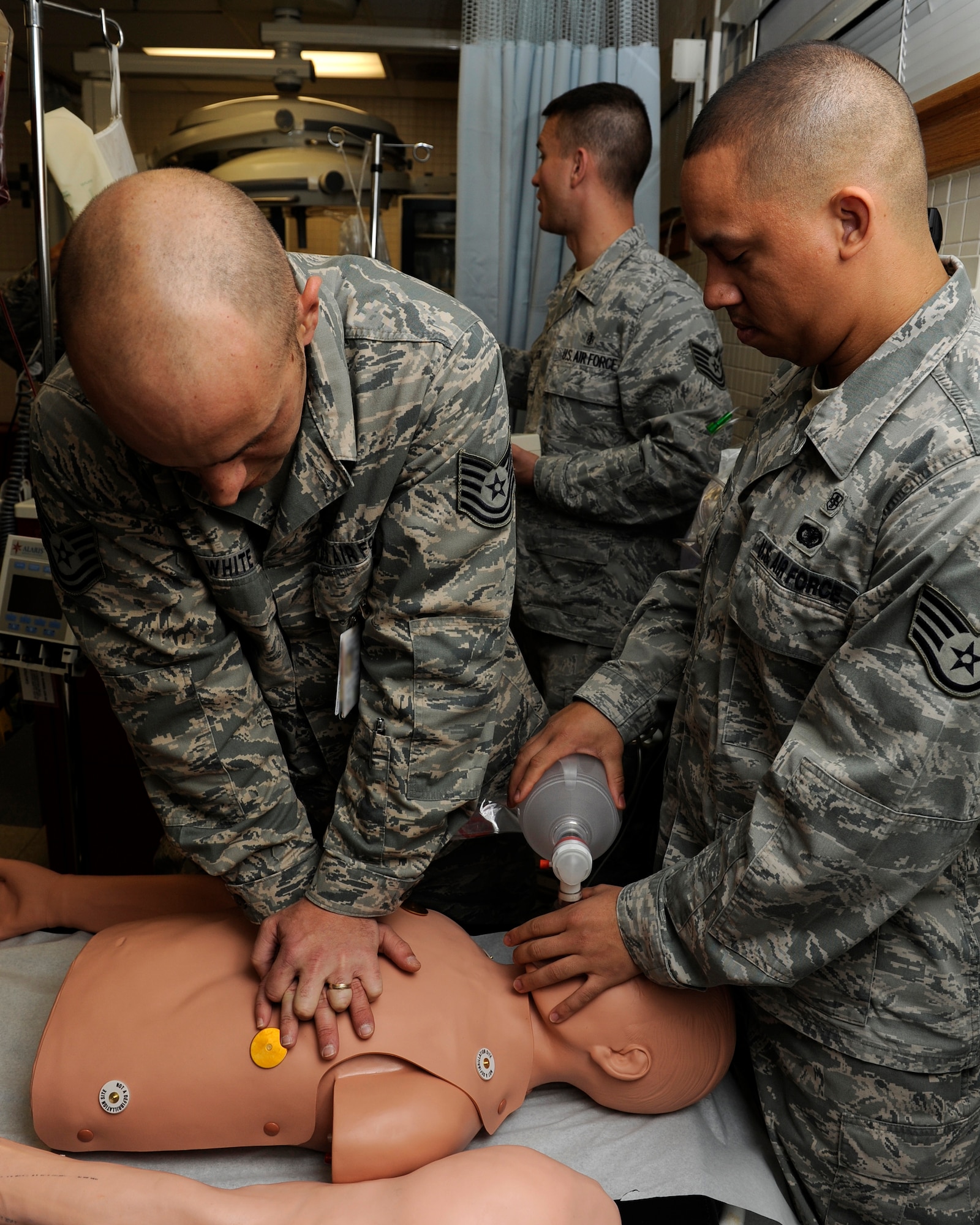 Technical Sgt. Daniel White, left, 8th Medical Group, and Staff Sgt. Branden Coneita, 8th Medical Operations Squadron perform CPR on a training dummy on Kunsan Air Base, Republic of Korea, Dec 11, 2012. The members of the 8th MDG participate in quarterly code blue training to prepare them for cardiorespiratory emergencies. (U.S. Air Force photo by Senior Airman Marcus Morris/released)