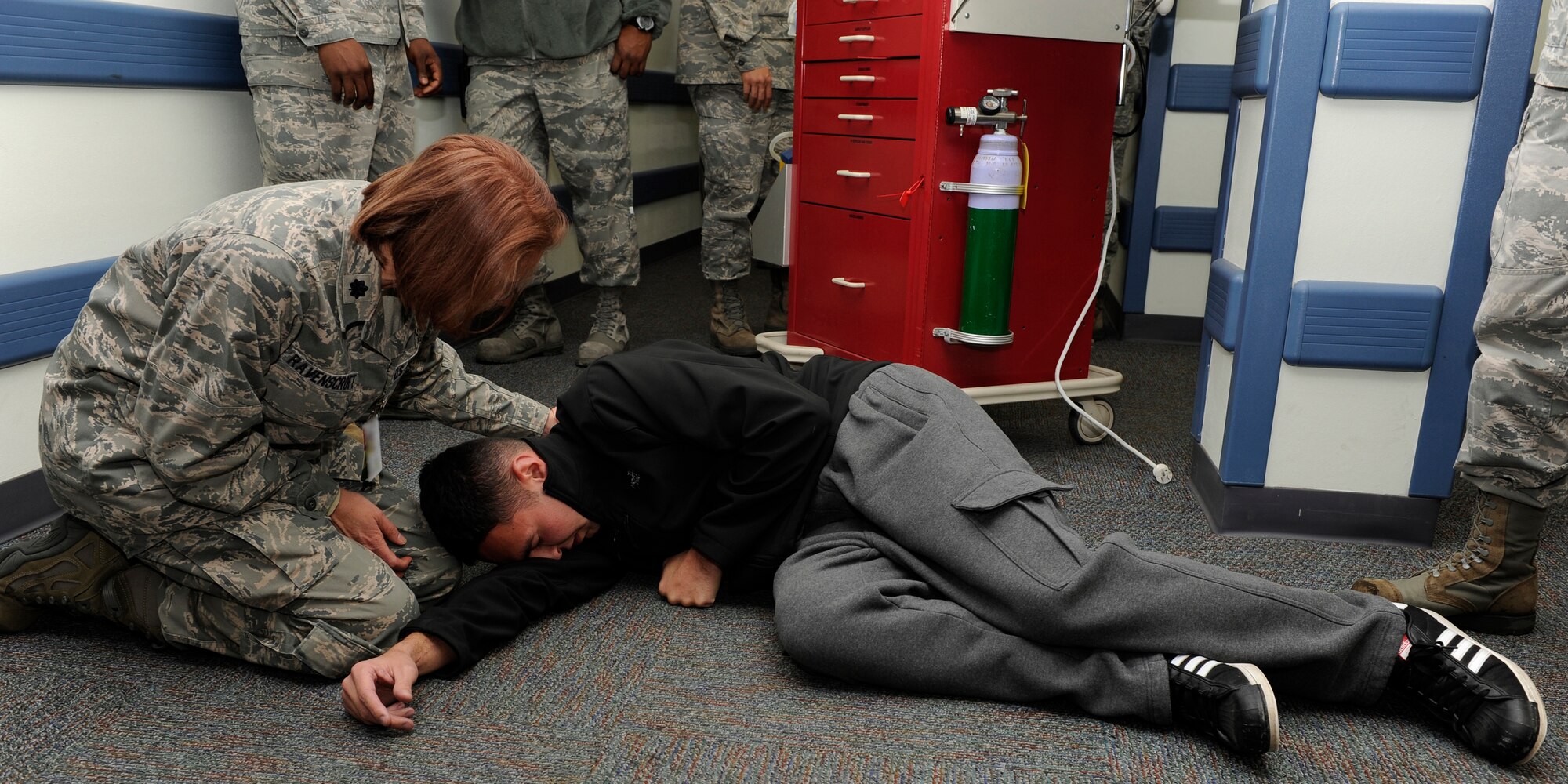 Lt. Col. Jennifer Ravenscroft, 8th Medical Group, responds to a patient who is having trouble breathing on Kunsan Air Base, Republic of Korea, Dec 11, 2012. The patient was part of a training exercise to see how medical personnel respond to an emergency. (U.S. Air Force photo by Senior Airman Marcus Morris/released)