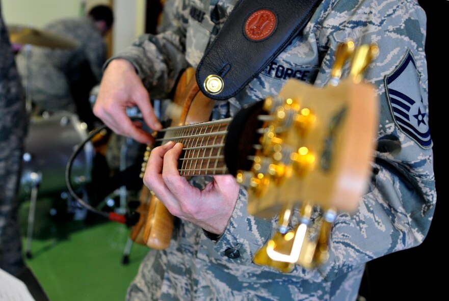 U.S. Air Force Master Sgt. Jeremy Laukhuf, U.S. Air Force Band of the Pacific-Asia Jazz Combo bassist, tunes his bass for a performance at the Misawa Municipal First Preschool Dec. 10, 2012, Misawa City, Japan.  The band is a five-piece arrangement consisting of drums, base, guitar, saxophone and keyboard. (U.S. Air Force photo by Tech. Sgt. Phillip Butterfield)