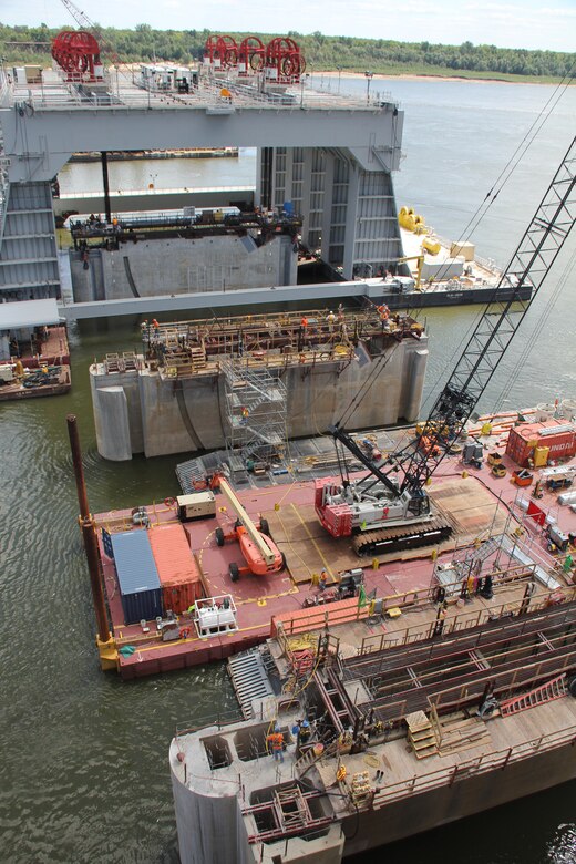 The catamaran barge lowers the third of six 2,000-ton lower pier shells into the Ohio River Sept. 8 during construction of the dam phase of the Olmsted Locks and Dam project. The steel reinforced concrete shells are part of the tainter gate section of the dam being built 17 miles upstream of the confluence of the Ohio and Mississippi rivers on the busiest stretch in America of the inland waterways.
 
(U.S. Army Corps of Engineers photo by Bill Gilmour)
