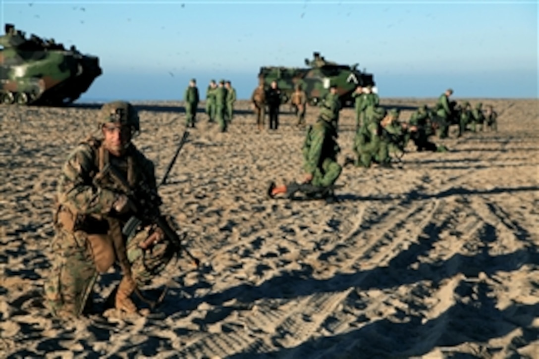 U.S. Marines and Singaporean soldiers take a break on Green Beach during exercise Valiant Mark 2012 at Marine Corps Base Camp Pendleton, Calif., on Dec. 10, 2012.  Valiant Mark is an annual exercise conducted by U.S. Marines and the Singapore Armed Forces in order to maintain a high level of interoperability, enhanced military to military relations and to enrich mutual combat capabilities through combined training. 