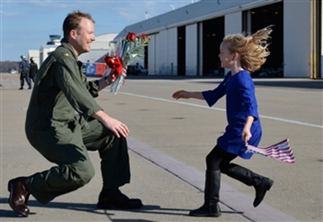 Lt. Cmdr. Pat Hart is reunited with his daughter during a homecoming celebration at Naval Air Station Oceana, Va., on Dec. 18, 2012.  Hart is assigned to Strike Fighter Squadron 143, which was part of Carrier Air Wing 7 aboard the USS Dwight D. Eisenhower (CVN 69).  The Eisenhower was deployed to the 5th and 6th Fleet areas of responsibility to conduct maritime security operations and theater security cooperation efforts.  