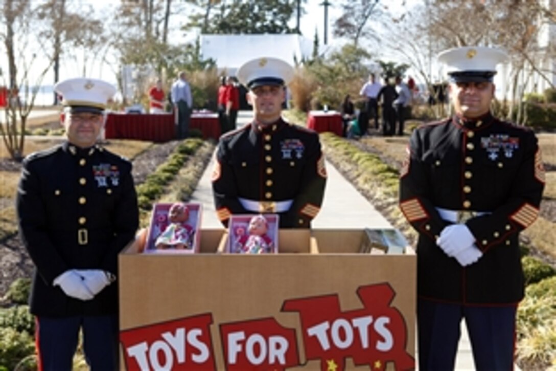 Marines stand post at a volunteer collection box for Toys for Tots at the annual holiday reception on Marine Corps Base Camp Lejeune, N.C., Dec. 12, 2012. The Marine Corps Reserve has sponsored the Toys for Tots program to give toys to needy children since 1947.