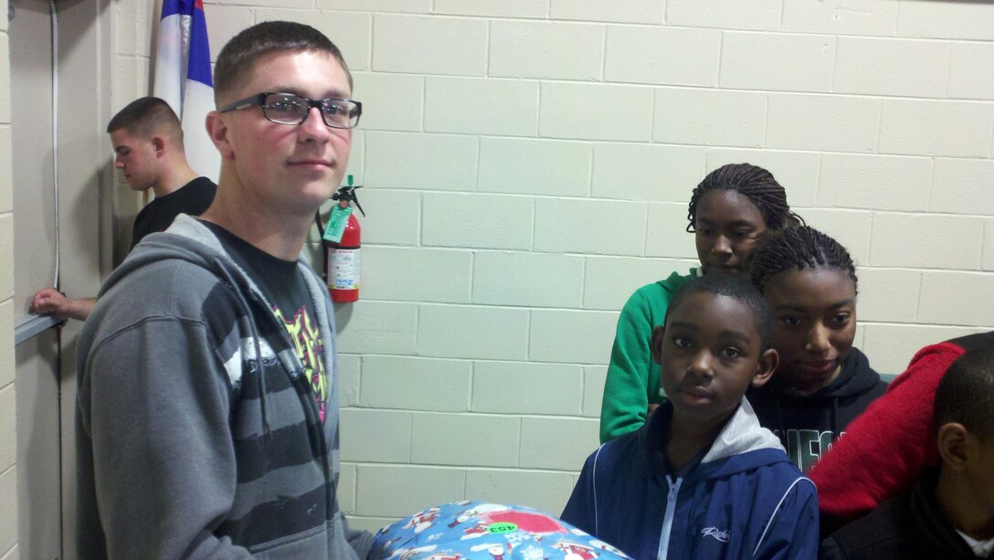 Marines with Marine Wing Support Squadron 273 volunteer at the Praise Assembly of God church in Beaufort, S.C. to help pass out approximately 500 gifts to children, Dec. 19. Children were able to jump in bounce houses, pet animals, play games, and eat food. Volunteering in the community offers Marines a chance to give back.
