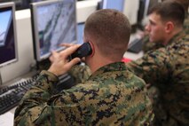 Staff Sgt. David L. Hampton, a motor transportation operations chief with 2nd Supply Battalion, 2nd Marine Logistics Group, calls in his situation to the unit’s combat operations center during a training exercise at Camp Johnson, N.C., Dec. 19, 2012. Hampton and other Marines with the unit carried out missions with a digital-convoy simulator while COC personnel relayed instructions to the servicemembers on the simulators.