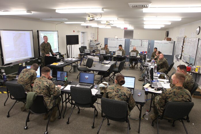 Second Lt. Evan C. Malone, the watch officer for 2nd Supply Battalion, 2nd Marine Logistics Group’s combat operations center training exercise, briefs COC personnel during the unit’s first day of simulations aboard Camp Johnson, N.C., Dec. 19, 2012. The unit used the base’s Marine Air-Ground Task Force Integrated Systems Training Center to test their chain of command structure during a series of operations conducted on digital simulators.