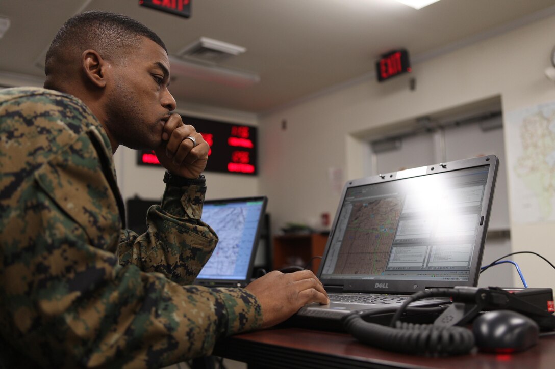 Warrant Officer Terence D. Bennett, a participant in 2nd Supply Battalion, 2nd Marine Logistics Group’s training exercise at Marine Air-Ground Task Force Integrated Systems Training Center aboard Camp Johnson, N.C., monitors his unit’s area of operations during a simulation Dec. 19, 2012. Bennett monitored activities in his area of responsibility and helped coordinate the combat operations center’s efforts to conduct missions during a variety of scenarios.