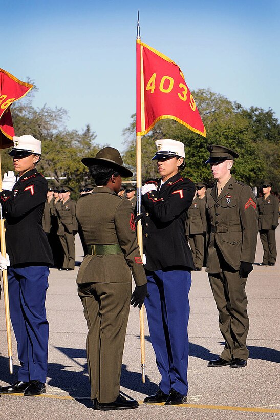 Pfc. Victoria Pena, honor graduate of platoon 4039, returns her platoon's guidon to Staff Sgt. Maria Zalwango, a drill instructor with the platoon during their graduation aboard Parris Island, S.C., Dec. 21, 2012. Only the honor graduates, such as Pena, Cape Coral, Fla., are given this opportunity during one of the last moments before graduation. 