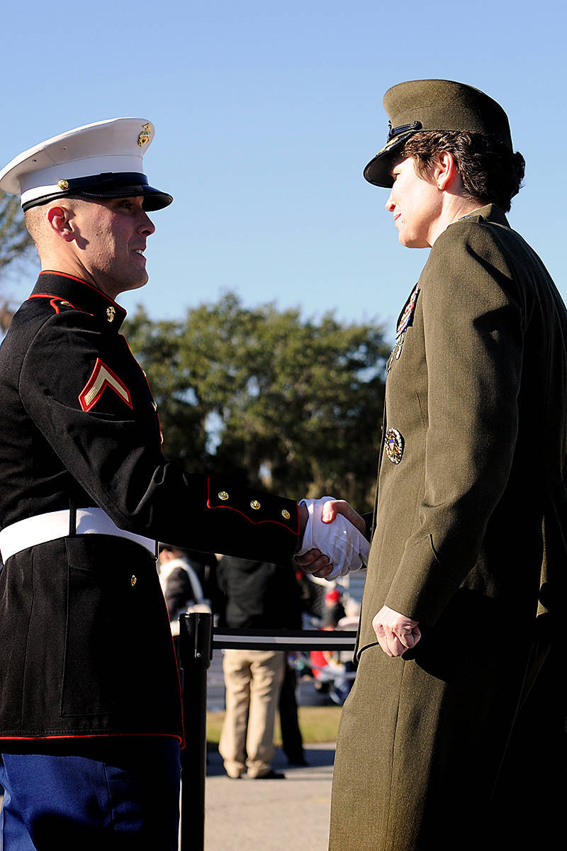 Pfc. Matthew Brahdam, honor graduate of platoon 1097, shakes hands with Brig. Gen. Lori Reynolds, Commanding General of Marine Corps Recruit Depot Parris Island, aboard Parris Island, S.C., Dec. 21, 2012. Bradham will be able to spend time with his family in Augusta, Ga., while he enjoys his well-deserved leave. 