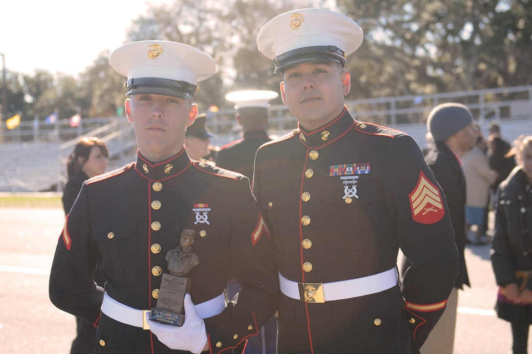 Pfc. John Picerno, honor graduate of platoon 1100, stands with his recruiter, Sgt. Erick Ambriz, aboard Parris Island, S.C., Dec. 21. 2012. Picerno is not only the honor graduate of platoon 1100, but also holds the title of company honor graduate of Charlie Company.