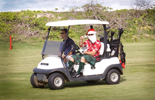 MARINE CORPS BASE HAWAII - Matt C. Somerville, festively dressed as a Scottish Santa, throws up the shaka as he drives a golf cart to the next hole during the Commander’s Cup Golf Classic at the Kaneohe Klipper Golf Course Complex, Dec. 14, 2012. “I’m playing with the Christmas spirit at heart and I want to pass the spirit on to others,” Somerville said. “I’m enjoying myself and with the help of my elves [fellow teammates], our team should do quite well.” (Official U.S. Marine Corps photo by Cpl. Vanessa M. American Horse)