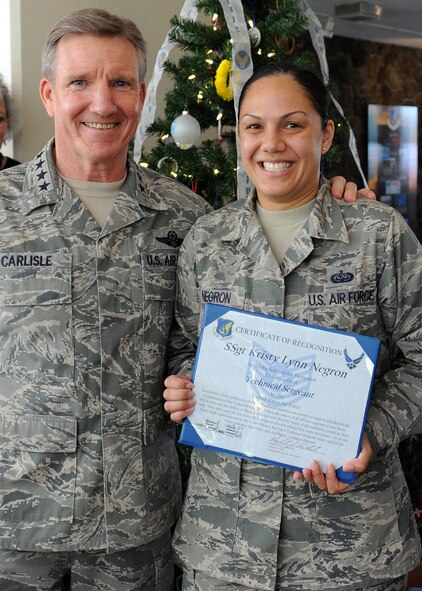 Gen. Herbert "Hawk" Carlisle, Pacific Air Forces commander, presents Staff Sgt. Kristy Lynn Negron, non-commissioned officer-in-charge of PACAF Executive Services, with a certificate of recognition for her Stripes for Exceptional Performers promotion to technical sergeant, at PACAF Headquarters, Hawaii, Dec. 20, 2012. The STEP program allows major commands, field operating agencies, direct reporting unit commanders, and senior Air Force officers with large enlisted populations to select a limited number of Airmen with exceptional potential for promotion to the grades of staff sergeant through master sergeant. (U.S. Air Force photo/ Tech. Sgt. Jerome S. Tayborn/Released)