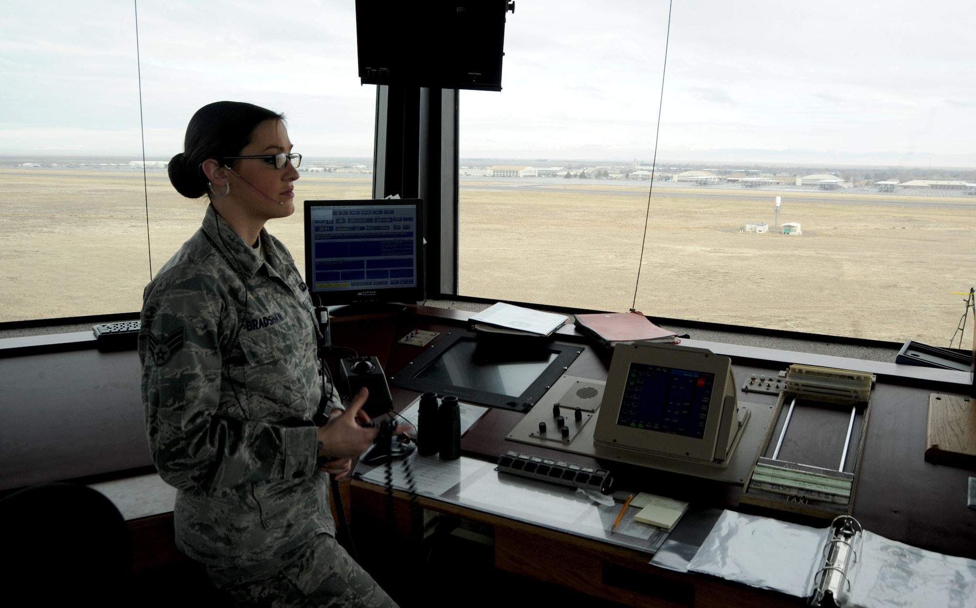 U. S. Air Force Senior Airman Jennifer Bradshaw, 366th Operations Support Squadron air traffic controller, stands inside the tower watching an aircraft land Dec. 13, 2012, at Mountain Home Air Force Base, Idaho. Air traffic control Airmen assigned to the 366th OSS respond and assist aircraft twenty-four hours a day. (U. S. Air Force photo/Senior Airman Benjamin Sutton)