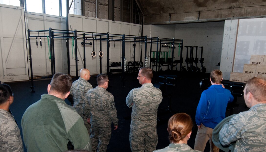 Col. Mark Weatherington, 28th Bomb Wing commander, Chief Master Sgt. Kevin Peterson, 28th BW command chief, and members of the wing, tour the new fitness area inside the Pride Hangar on Ellsworth Air Force Base, S.D., Dec. 19, 2012. In addition to a running track and an astro-turf field, the Pride Hangar now hosts a new $60,000 fitness area featuring professional grade exercise equipment to give Airmen an alternative to working out in the Bellamy Fitness Center. (U.S. Air Force photo by Airman 1st Class Kate Thornton-Maurer)