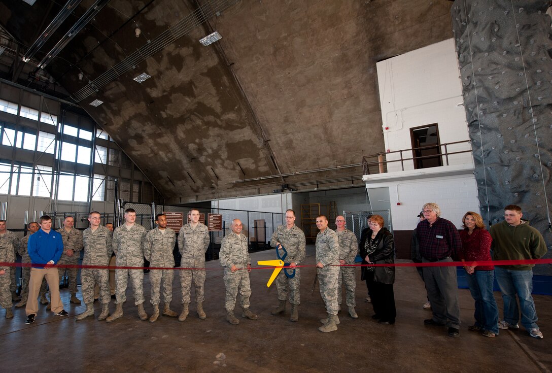 Col. Mark Weatherington (center), 28th Bomb Wing commander, and Col. Thomas Goulter Jr., 28th Mission Support Group commander, cut the ribbon during a grand opening for the rock climbing wall and fitness area in the Pride Hangar on Ellsworth Air Force Base, S.D., Dec. 19,2012. To ensure participants’ safety, climbers must be supervised at all times by a certified operator who is trained to oversee climbing activities. For scheduling and more information, call Outdoor Recreation at (605) 385-2996. (U.S. Air Force photo by Airman 1st Class Kate Thornton-Maurer/Released)