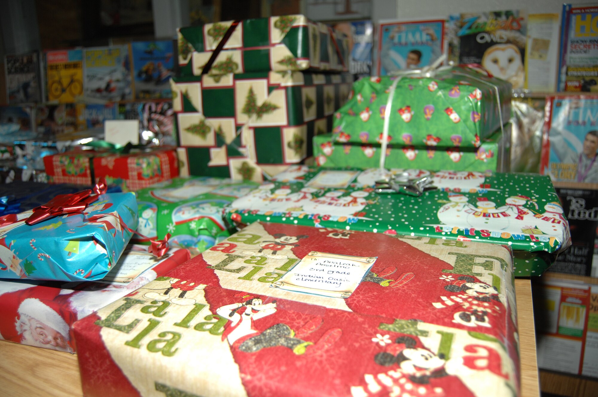 Presents are placed on tables in anticipation of the children of Indian Oasis Elementary School during the Santa’s in Blue event Dec. 20., in Sells, Ariz. This year, the program will give out roughly 1,400 gifts. (U.S. Air Force photo by Senior Airman Michael Washburn/Released)