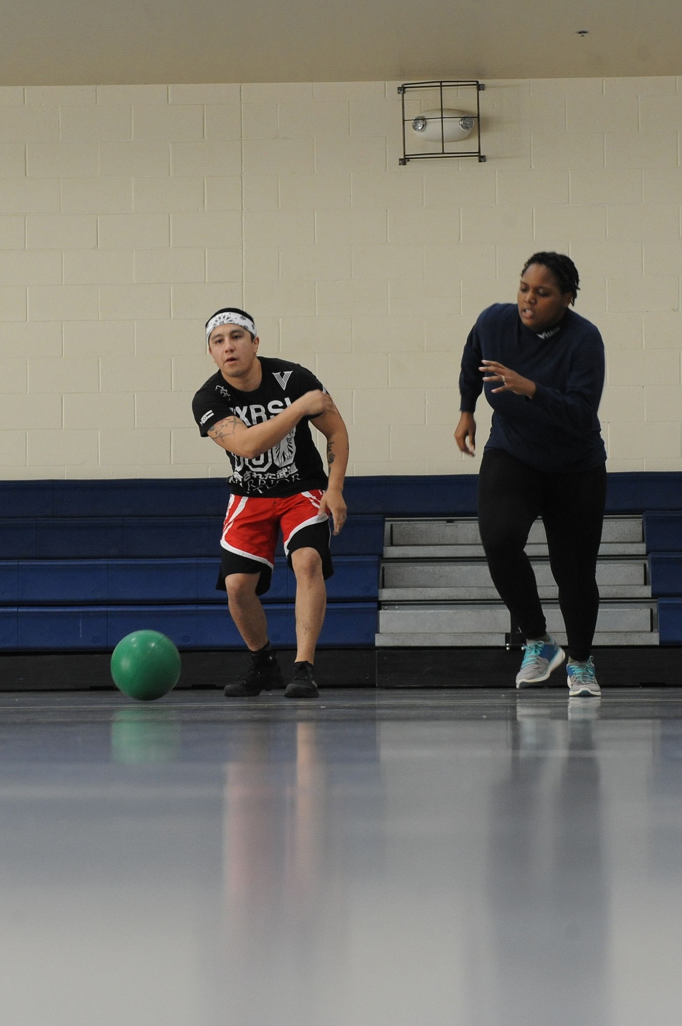 Staff Sgt. Jeremy Caudillo, 2nd Force Support Squadron fitness center supervisor, does an exercise drill with Staff Sgt. Crystal McElvane, 2 FSS unit deployment manager, on Barksdale Air Force Base, La., Dec. 20. During the drill, a ball is rolled and the other individual must run and retrieve it. The process is repeated for one minute to improve cardio. Caudillo competes in mixed martial arts and uses some of the exercises he learns to help Airmen stay fit to fight. (U.S. Air Force photo/Senior Airman Micaiah Anthony)