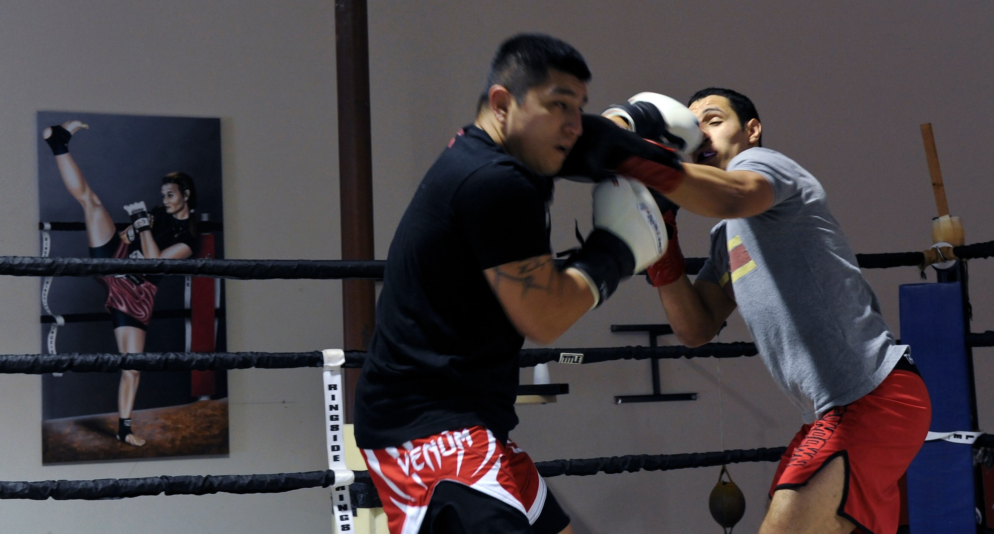 Staff Sgt. Jeremy Caudillo, left, and Airman 1st Class Justin Solorio, 2nd Force Support Squadron, trade punches during their sparring session at a local mixed martial arts gym in Bossier City, La., Dec. 12. Sparring helps fighters hone their timing, control their distance, speed, foot work, endurance, speed, and focus. Both Caudillo and Solorio work at the Fitness Center on Barksdale Air Force Base, La., and enjoy training and competing in MMA competitions. (U.S. Air Force photo/Senior Airman Micaiah Anthony)
