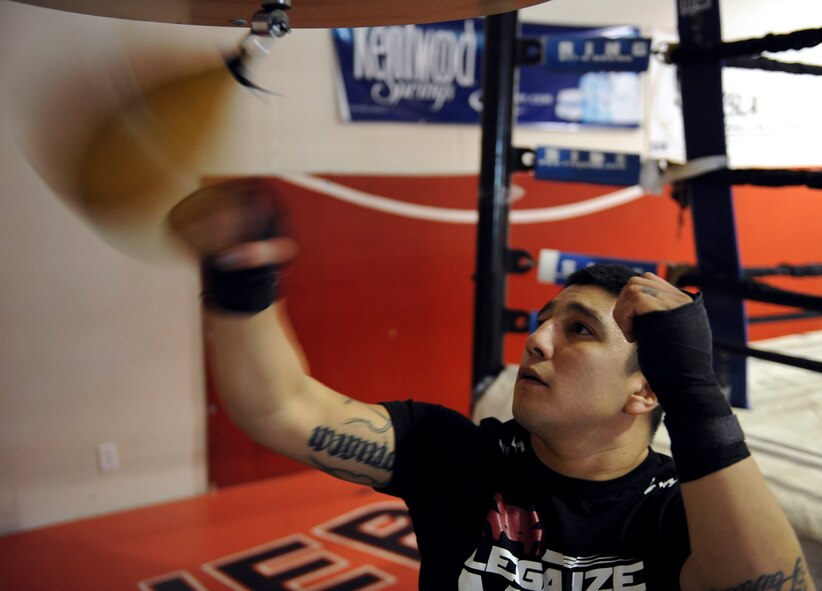 Staff Sgt. Jeremy Caudillo, 2nd Force Support Squadron fitness center supervisor, punches a speed bag at a local mixed martial arts gym in Bossier City, La., Dec. 12. Speed bags help fighters increase their hand-eye coordination, hand speed, rhythm and timing. Caudillo is currently training for his first professional MMA fight in March. (U.S. Air Force photo/Senior Airman Micaiah Anthony)